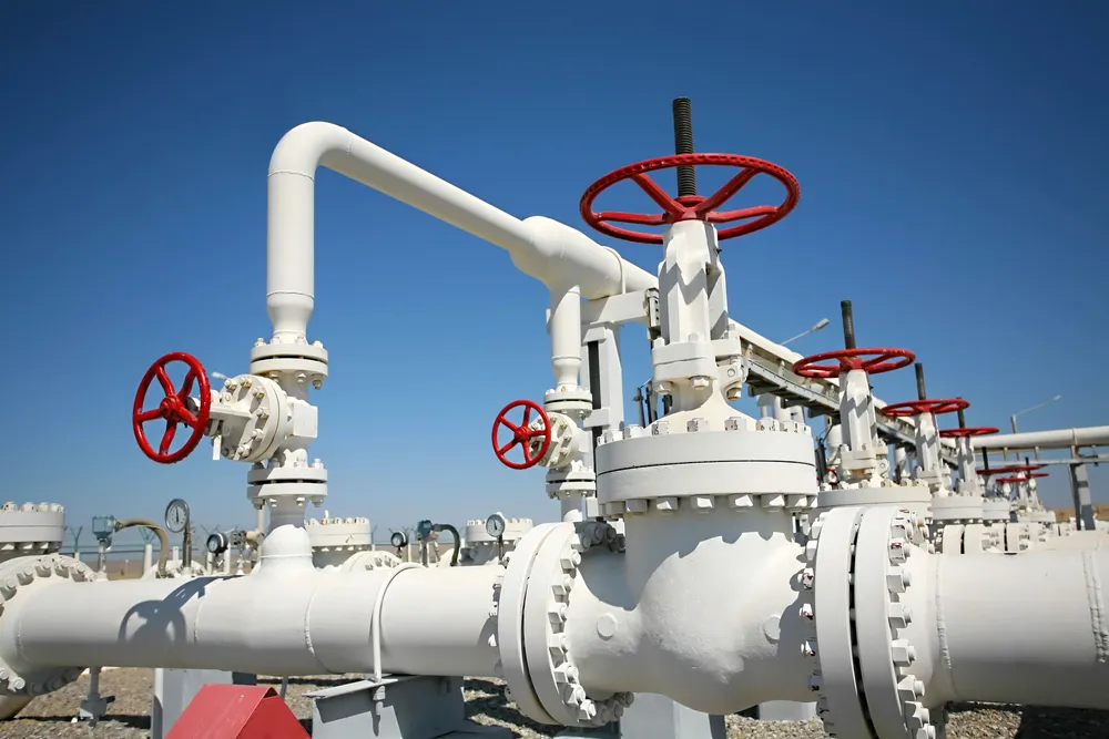 White process pipework with red valve handwheels